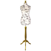 Mannequin torso with floral pattern on a wooden stand against a white background